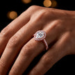 Pear cut halo lab-grown diamond engagement ring worn on hand in 18kt rose gold.