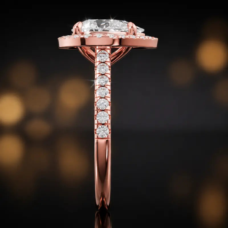Side profile of a pear cut halo lab-grown diamond engagement ring in 18kt rose gold.