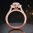 Side view of a pear cut halo lab-grown diamond engagement ring with diamond-set shoulders in 18kt rose gold.