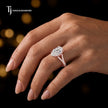 Pear cut split shank lab-grown diamond engagement ring worn on hand in 18kt rose gold.