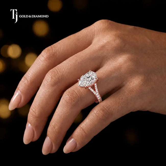 Pear cut split shank lab-grown diamond engagement ring worn on hand in 18kt rose gold.