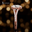 Side profile of a pear cut split shank lab-grown diamond engagement ring with diamond-set shoulders in 18kt rose gold.