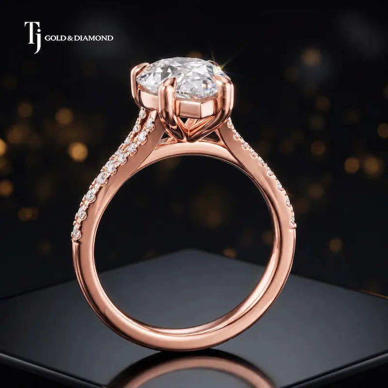 Side view of a pear cut split shank lab-grown diamond engagement ring featuring a four-claw cathedral setting in 18kt rose gold.
