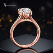 Side view of a pear cut split shank lab-grown diamond engagement ring featuring a four-claw cathedral setting in 18kt rose gold.