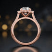 Side view of a round cut halo lab-grown diamond engagement ring with diamond-set shoulders in 18kt rose gold.