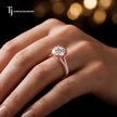 Round cut split shank lab-grown diamond engagement ring worn on hand in 18kt rose gold.