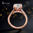 Side view of a round cut split shank lab-grown diamond engagement ring featuring a four-claw cathedral setting in 18kt rose gold.