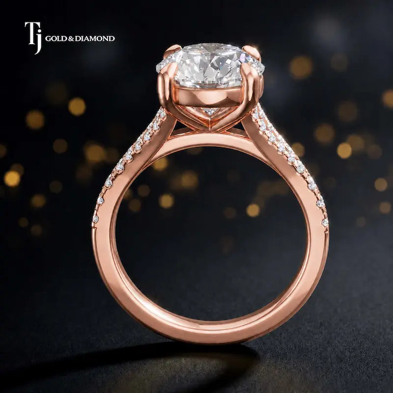 Side view of a round cut split shank lab-grown diamond engagement ring featuring a four-claw cathedral setting in 18kt rose gold.