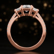 Front-on view of a radiant cut three-stone lab-grown diamond engagement ring in 18kt rose gold showing the setting profile