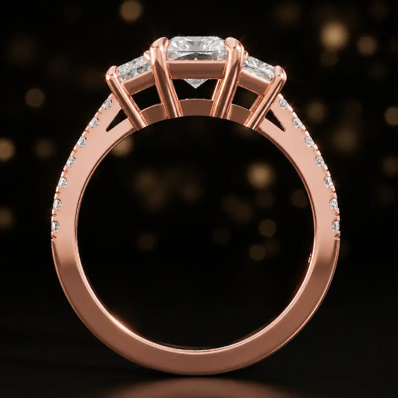 Front-on view of a radiant cut three-stone lab-grown diamond engagement ring in 18kt rose gold showing the setting profile