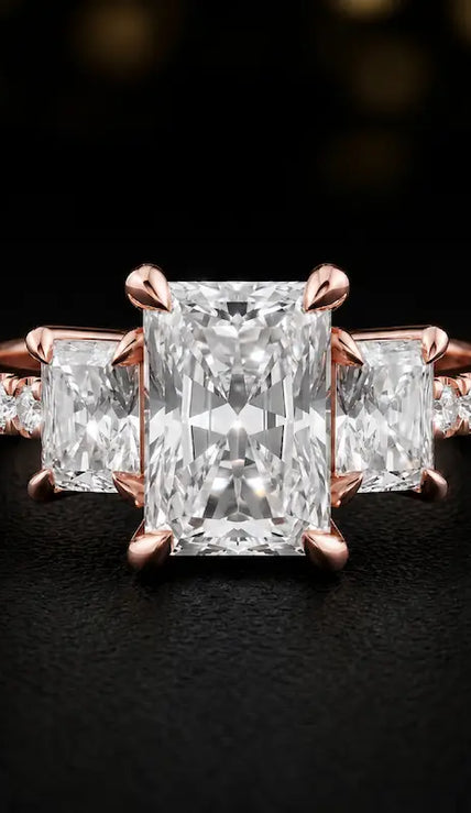Front view of a radiant cut three-stone lab-grown diamond engagement ring in 18kt rose gold with diamond shoulders