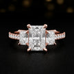 Front view of a radiant cut three-stone lab-grown diamond engagement ring in 18kt rose gold with diamond shoulders