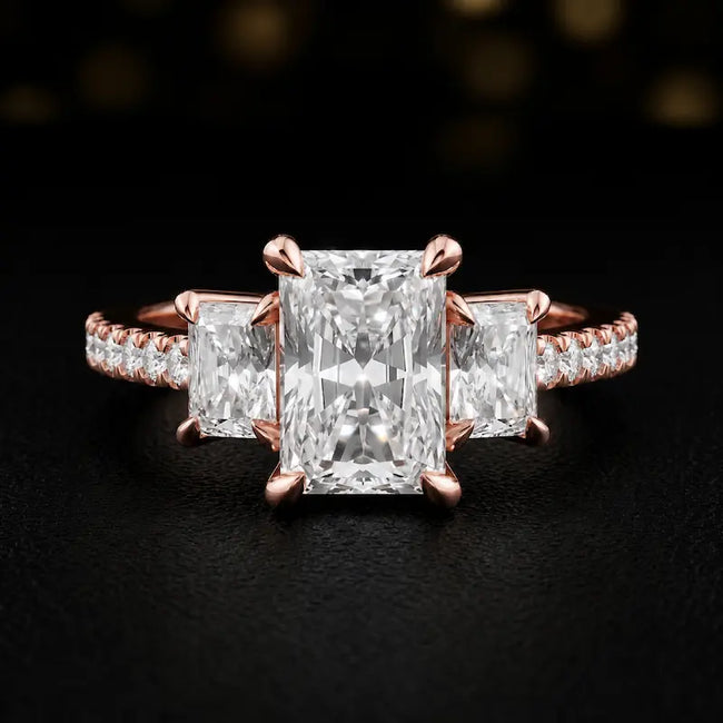 Front view of a radiant cut three-stone lab-grown diamond engagement ring in 18kt rose gold with diamond shoulders