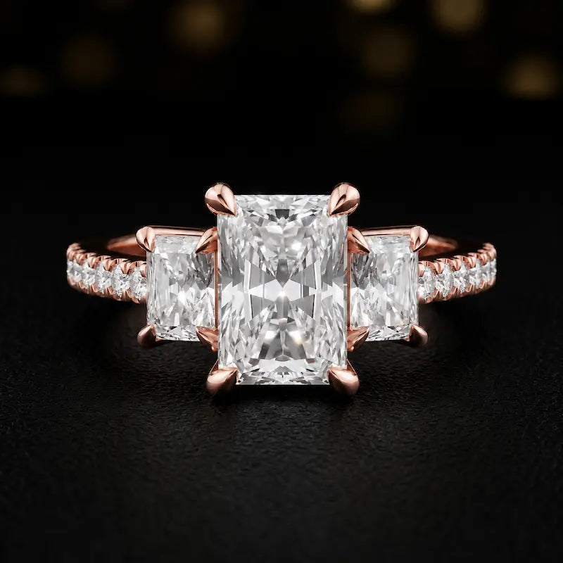 Front view of a radiant cut three-stone lab-grown diamond engagement ring in 18kt rose gold with diamond shoulders