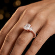 Radiant cut three-stone lab-grown diamond engagement ring in 18kt rose gold with diamond shoulders worn on hand