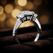 Angled view of a radiant cut three-stone lab-grown diamond engagement ring in 18kt white gold with diamond shoulders