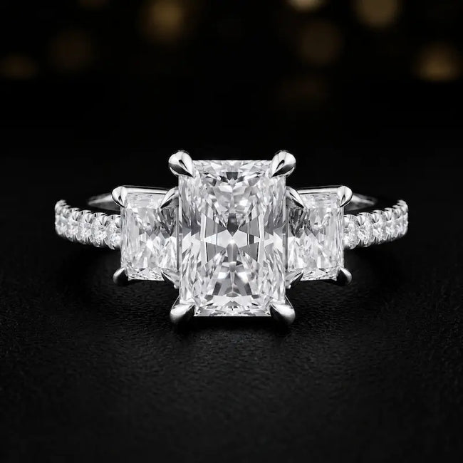 Front view of a radiant cut three-stone lab-grown diamond engagement ring in 18kt white gold with diamond shoulders