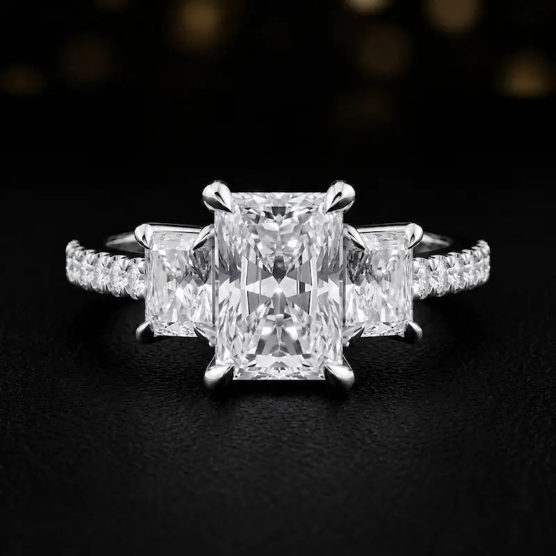 Front view of a radiant cut three-stone lab-grown diamond engagement ring in 18kt white gold with diamond shoulders