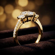 Angled view of a radiant cut three-stone lab-grown diamond engagement ring in 18kt yellow gold with diamond shoulders