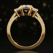 Front-on view of a radiant cut three-stone lab-grown diamond engagement ring in 18kt yellow gold showing the setting profile