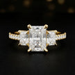 Front view of a radiant cut three-stone lab-grown diamond engagement ring in 18kt yellow gold with diamond shoulders