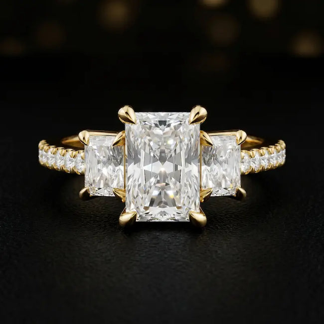 Front view of a radiant cut three-stone lab-grown diamond engagement ring in 18kt yellow gold with diamond shoulders
