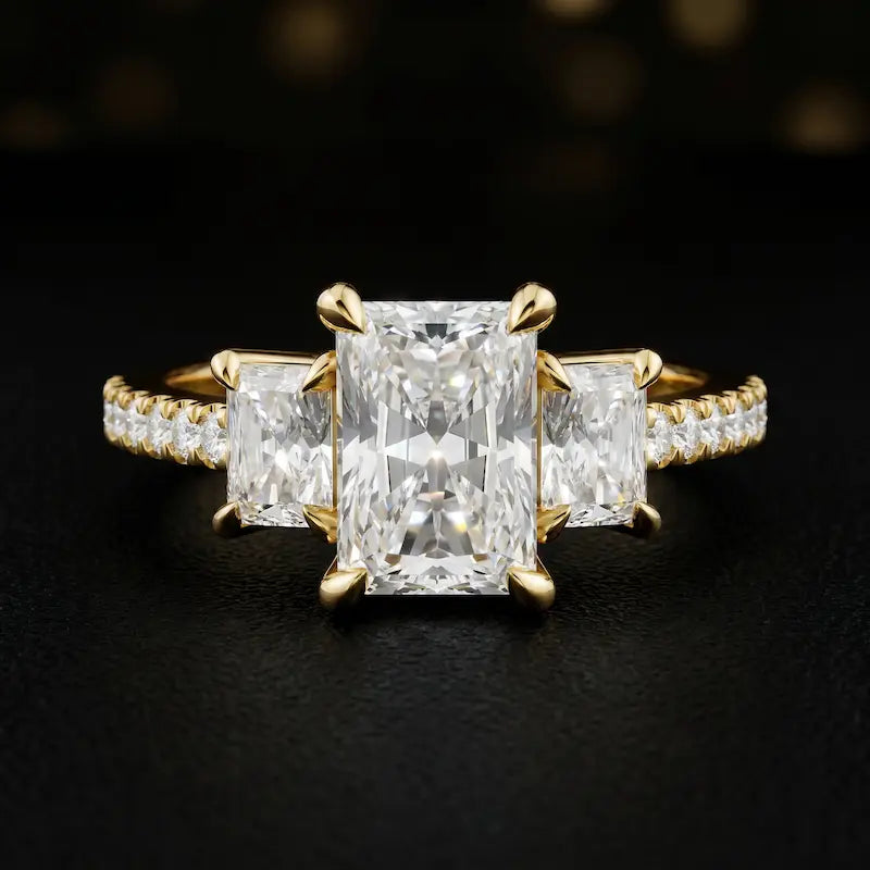 Front view of a radiant cut three-stone lab-grown diamond engagement ring in 18kt yellow gold with diamond shoulders