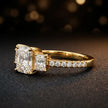 Side view of a radiant cut three-stone lab-grown diamond engagement ring in 18kt yellow gold with diamond shoulders