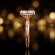 Side profile of 4-claw radiant cut engagement ring with hidden halo in 18kt rose gold