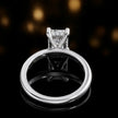 Back view of 4-claw radiant cut engagement ring with hidden halo in 18kt white gold