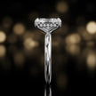 Side profile of 4-claw radiant cut engagement ring with hidden halo in 18kt white gold