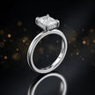 Side view of 4-claw radiant cut engagement ring with hidden halo in 18kt white gold