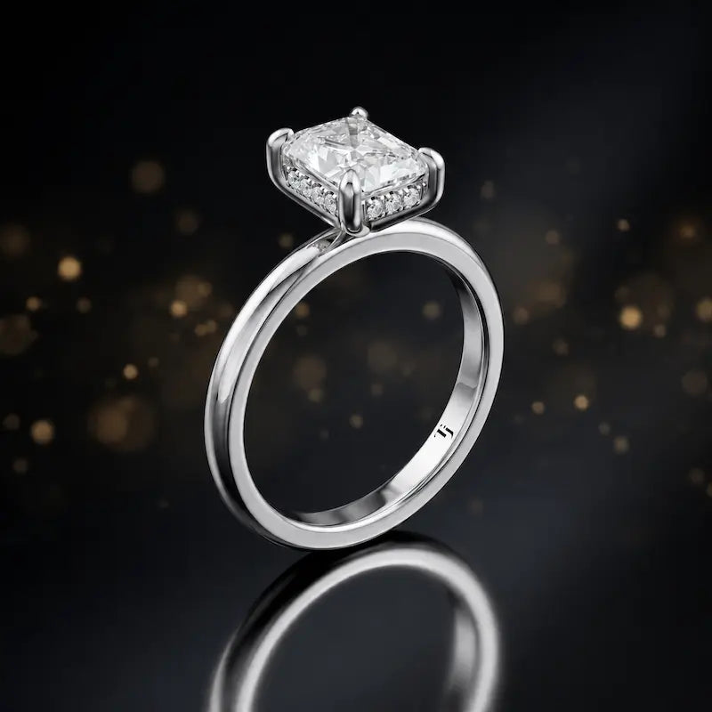 Side view of 4-claw radiant cut engagement ring with hidden halo in 18kt white gold