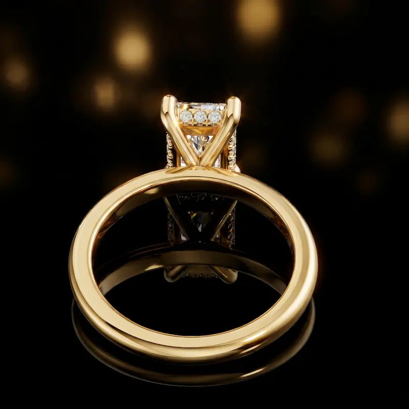 Back view of 4-claw radiant cut engagement ring with hidden halo in 18kt yellow gold