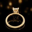 Back view of 4-claw radiant cut engagement ring with hidden halo in 18kt yellow gold
