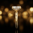 Side profile of 4-claw radiant cut engagement ring with hidden halo in 18kt yellow gold