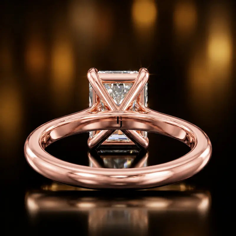 Back view of a 1.5 carat radiant cut diamond solitaire engagement ring showing the 4 claw setting and 18kt rose gold band by TJ Diamond
