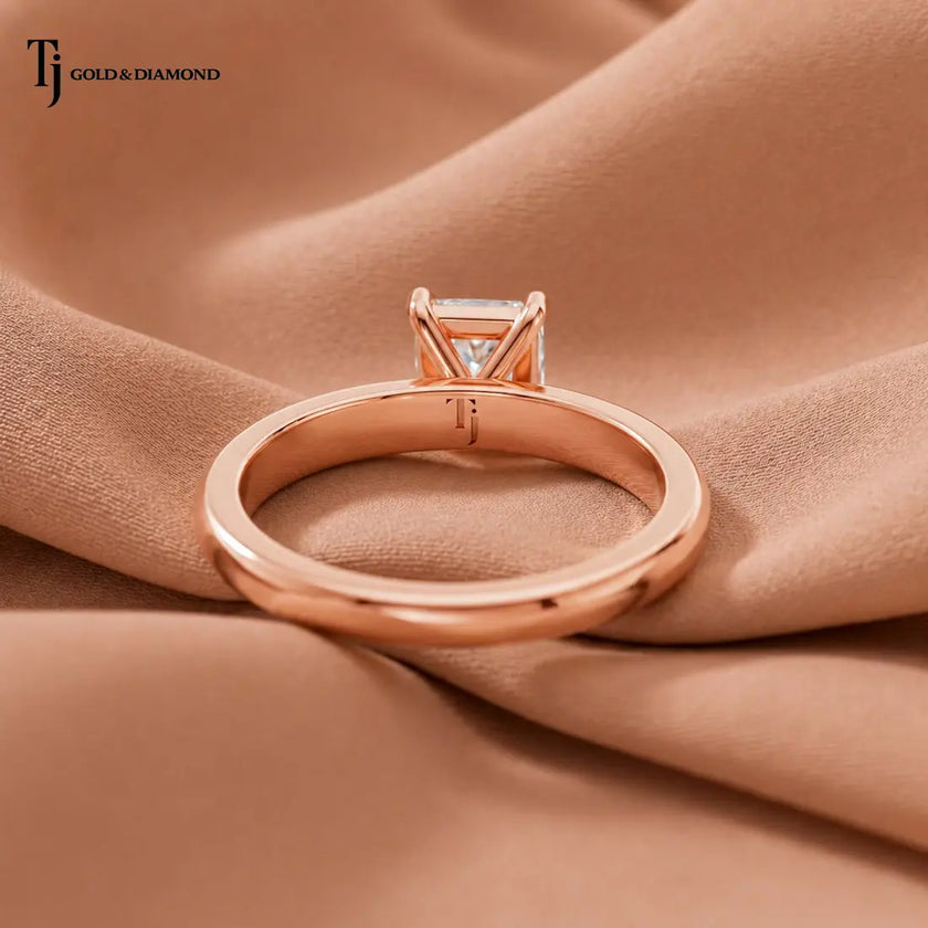 Back view of a 1.5 carat radiant cut diamond solitaire engagement ring showing the 18kt rose gold band and 4 claw setting by TJ Diamond