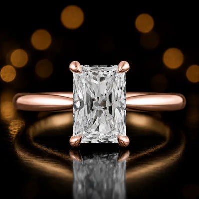 Front view of a 1.5 carat radiant cut diamond solitaire engagement ring in an 18kt rose gold 4 claw setting by TJ Diamond