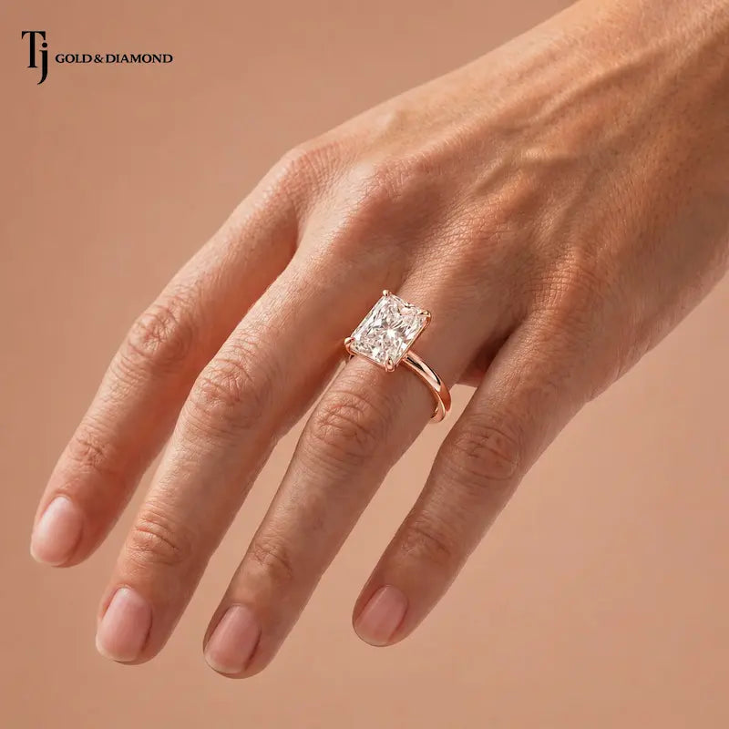 1.5 carat radiant cut diamond solitaire engagement ring in an 18kt rose gold 4 claw setting worn on a hand, by TJ Diamond