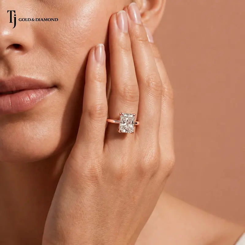 1.5 carat radiant cut diamond solitaire engagement ring in an 18kt rose gold 4 claw setting worn on a model, by TJ Diamond