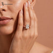 1.5 carat radiant cut diamond solitaire engagement ring in an 18kt rose gold 4 claw setting worn on a model, by TJ Diamond