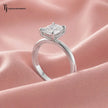1.5 carat radiant cut lab-grown diamond solitaire engagement ring in 18kt white gold with a 4-claw setting, three-quarter angle view on pink silk
