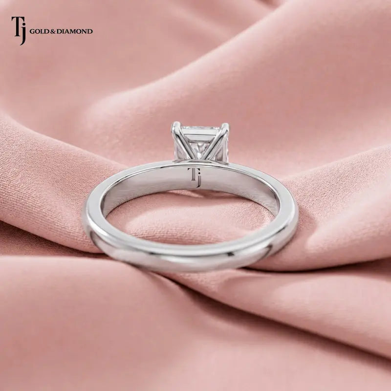 1.5 carat radiant cut lab-grown diamond solitaire engagement ring in 18kt white gold, back view on pink silk