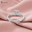 1.5 carat radiant cut lab-grown diamond solitaire engagement ring in 18kt white gold, back view on pink silk