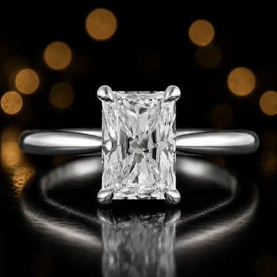 Front view of a 1.5 carat radiant cut diamond solitaire engagement ring in an 18kt white gold 4 claw setting by TJ Diamond