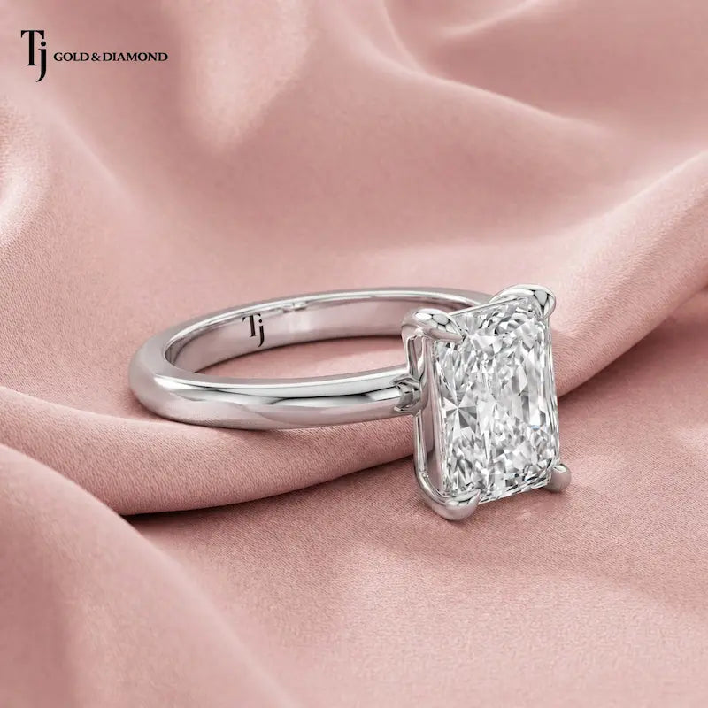 1.5 carat radiant cut lab-grown diamond solitaire engagement ring in 18kt white gold, side view on pink silk