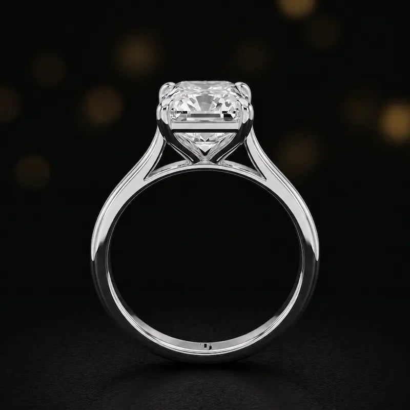 Front-on view of a 1.5 carat radiant cut diamond solitaire engagement ring showing the full 18kt white gold band and 4 claw cathedral setting by TJ Diamond