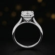 Front-on view of a 1.5 carat radiant cut diamond solitaire engagement ring showing the full 18kt white gold band and 4 claw cathedral setting by TJ Diamond