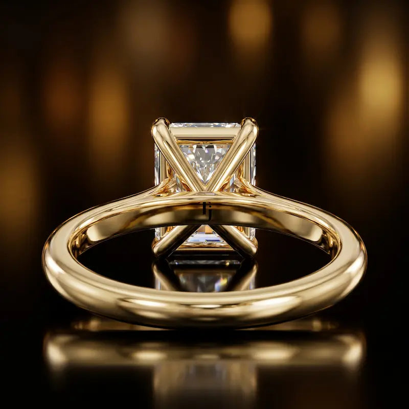 Back view of a 1.5 carat radiant cut diamond solitaire engagement ring showing the 4 claw setting and 18kt yellow gold band by TJ Diamond